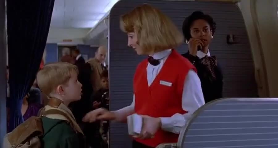 Kevin on the plane talking to a flight attendant in Home Alone 2