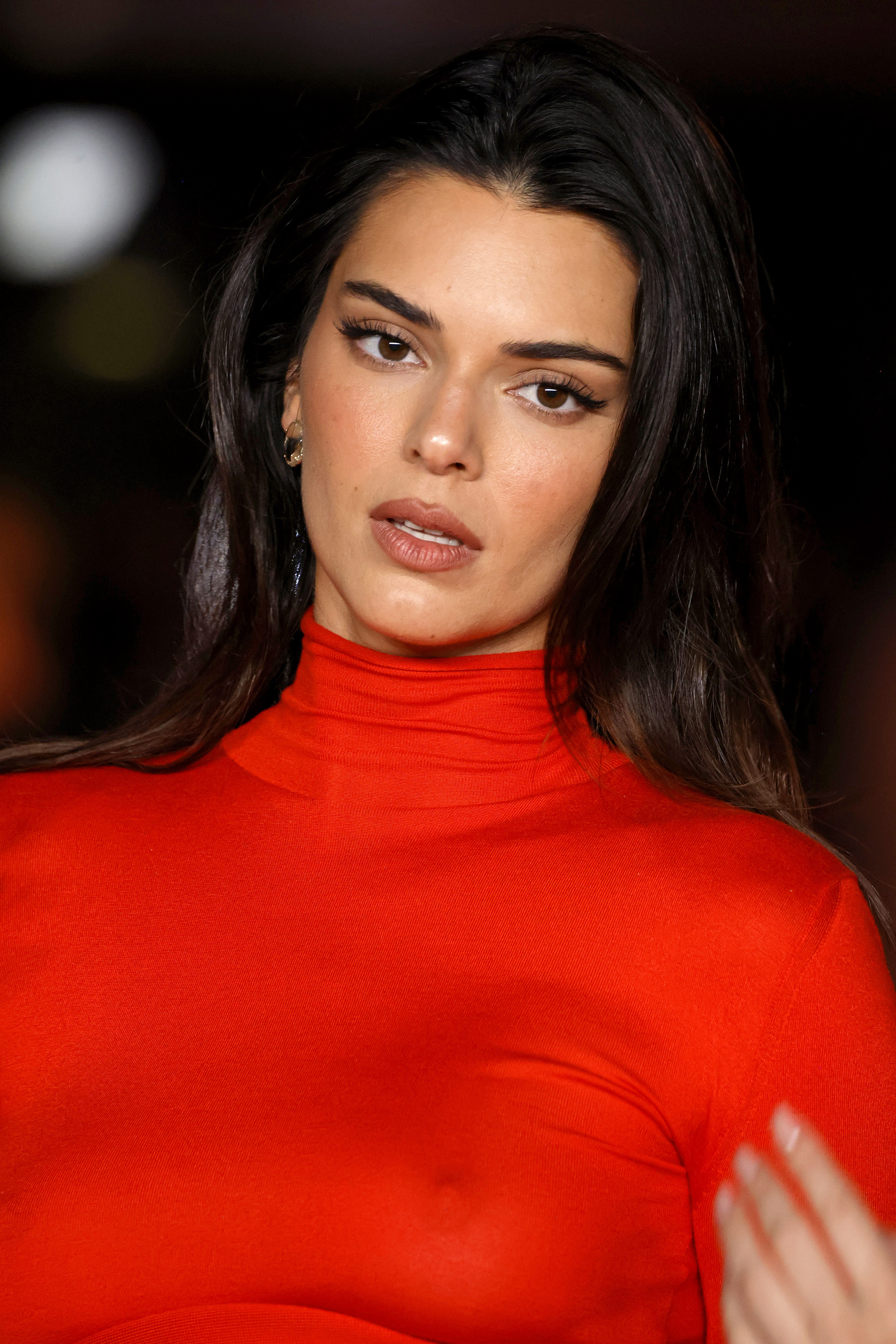 Close-up of Kendall in a red turtleneck