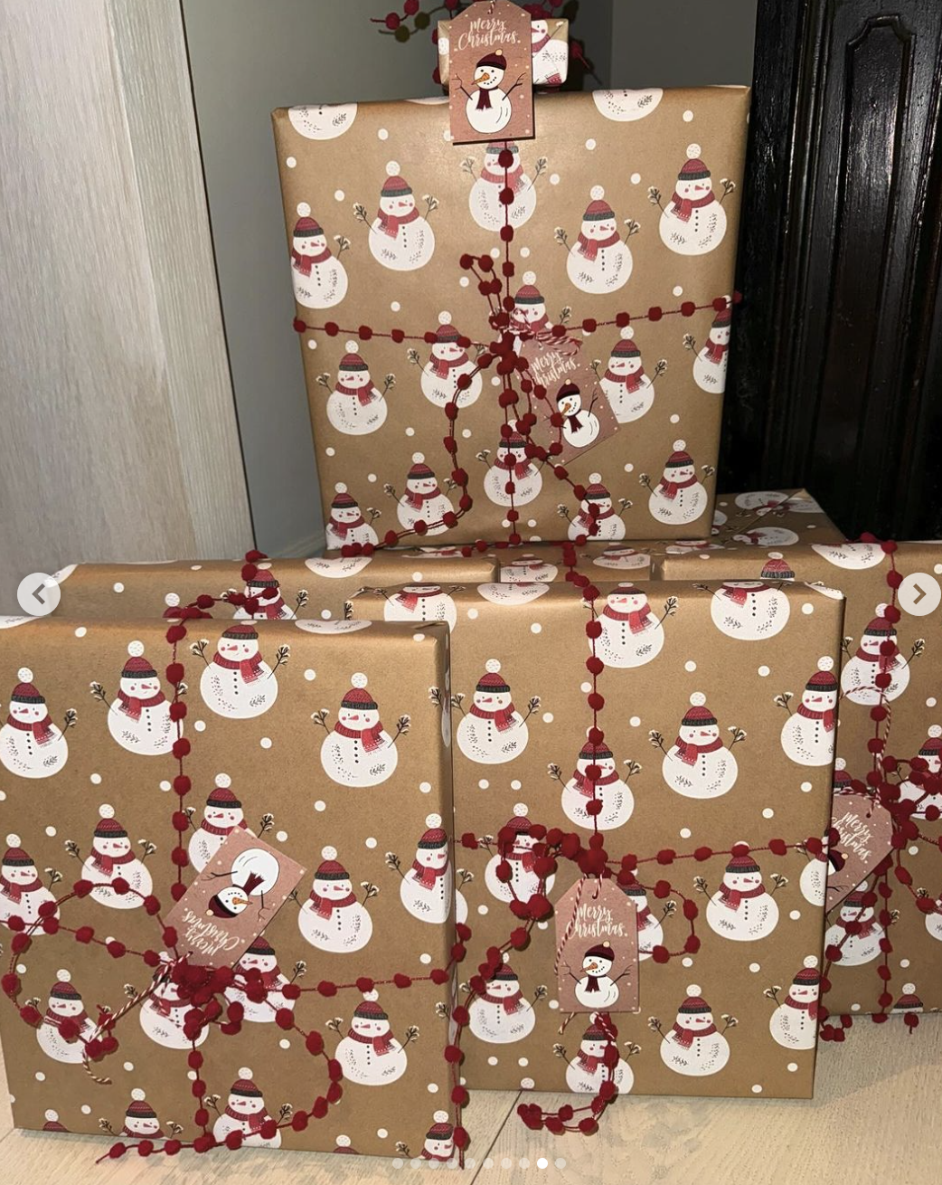 Gifts with snowman wrapping paper and ribbon that looks like strings of small red balls