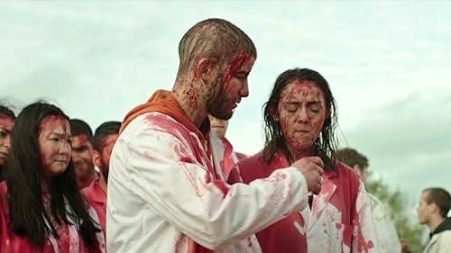 Garance Miller and Rabah Nait Oufella wearing blood-stained lab coats.