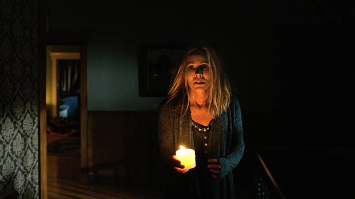 Teresa Palmer holding a candle.