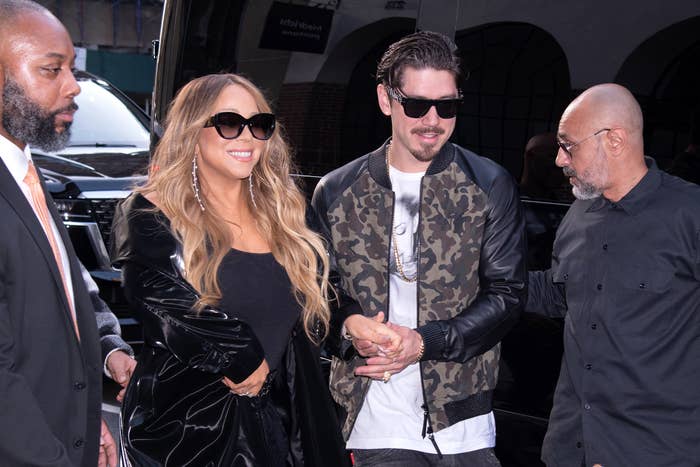 Mariah and Bryan smiling, standing together, and wearing sunglasses