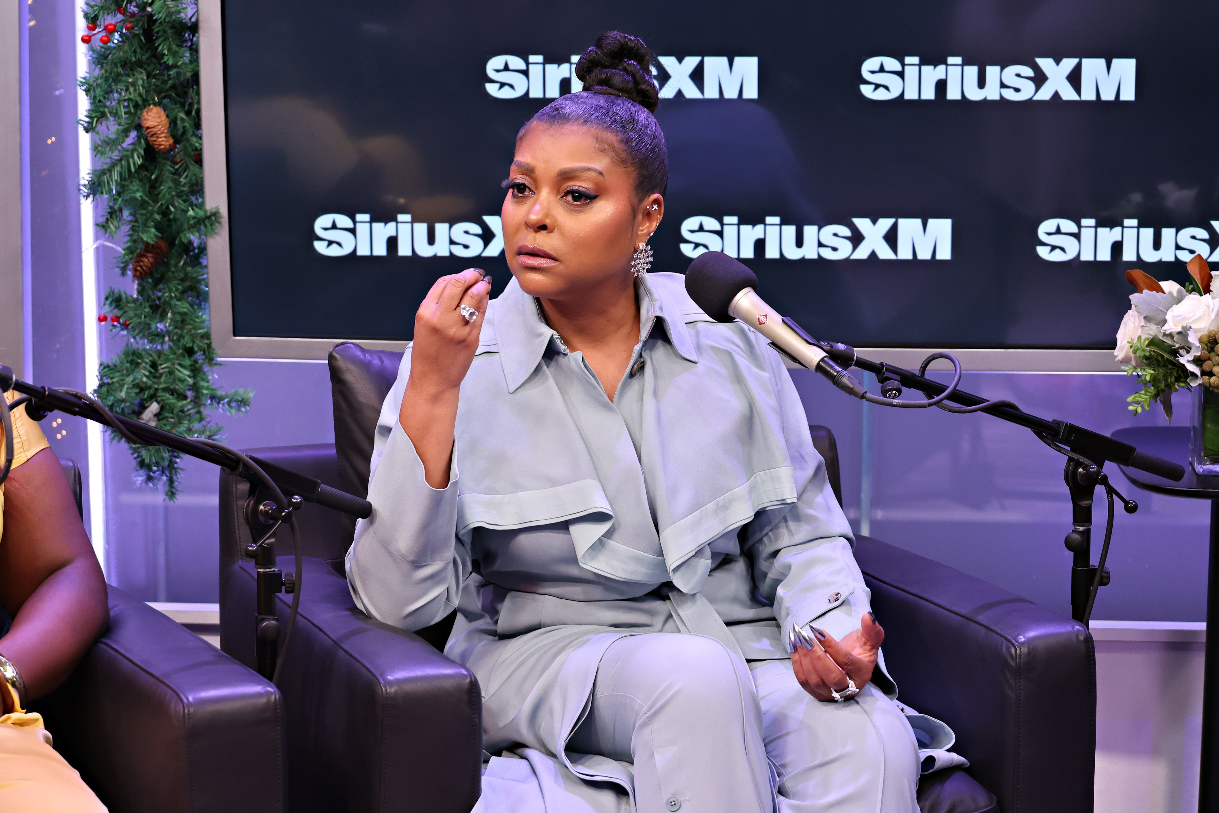 Close-up of Taraji sitting in the SiriusXM studio in front of a microphone