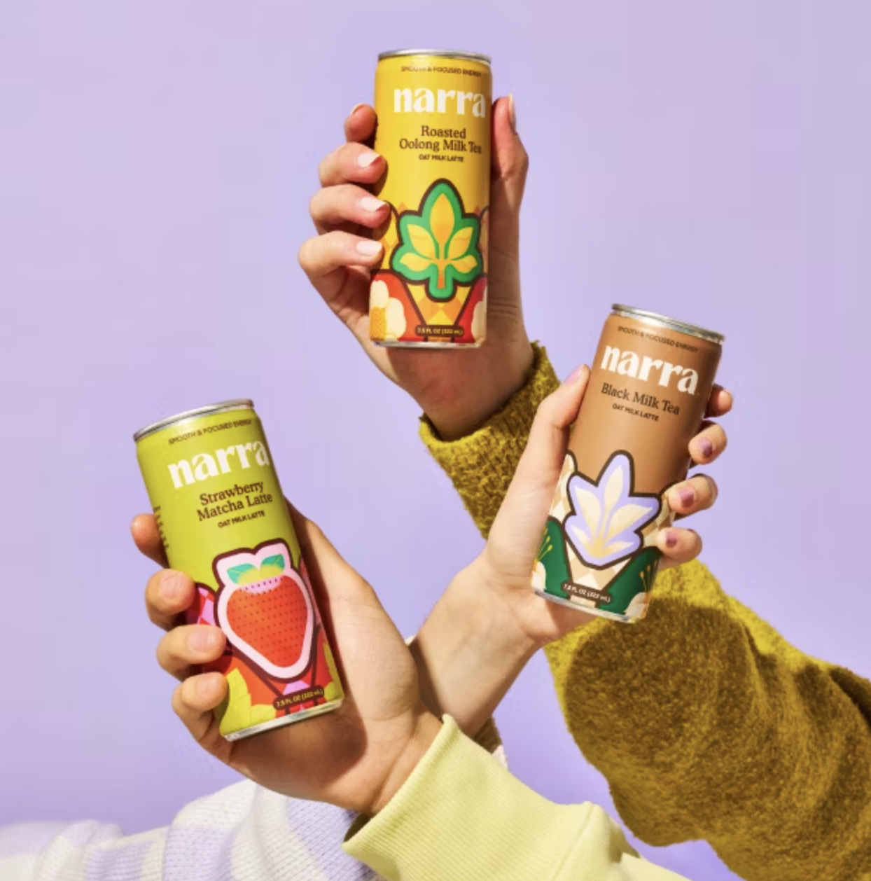 Three models holding cans of Narra