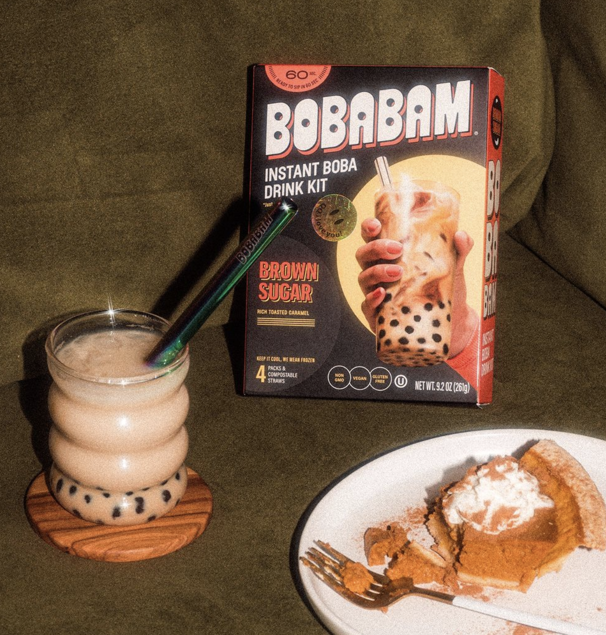Brown sugar boba pack next to glass of drink and pumpkin pie.