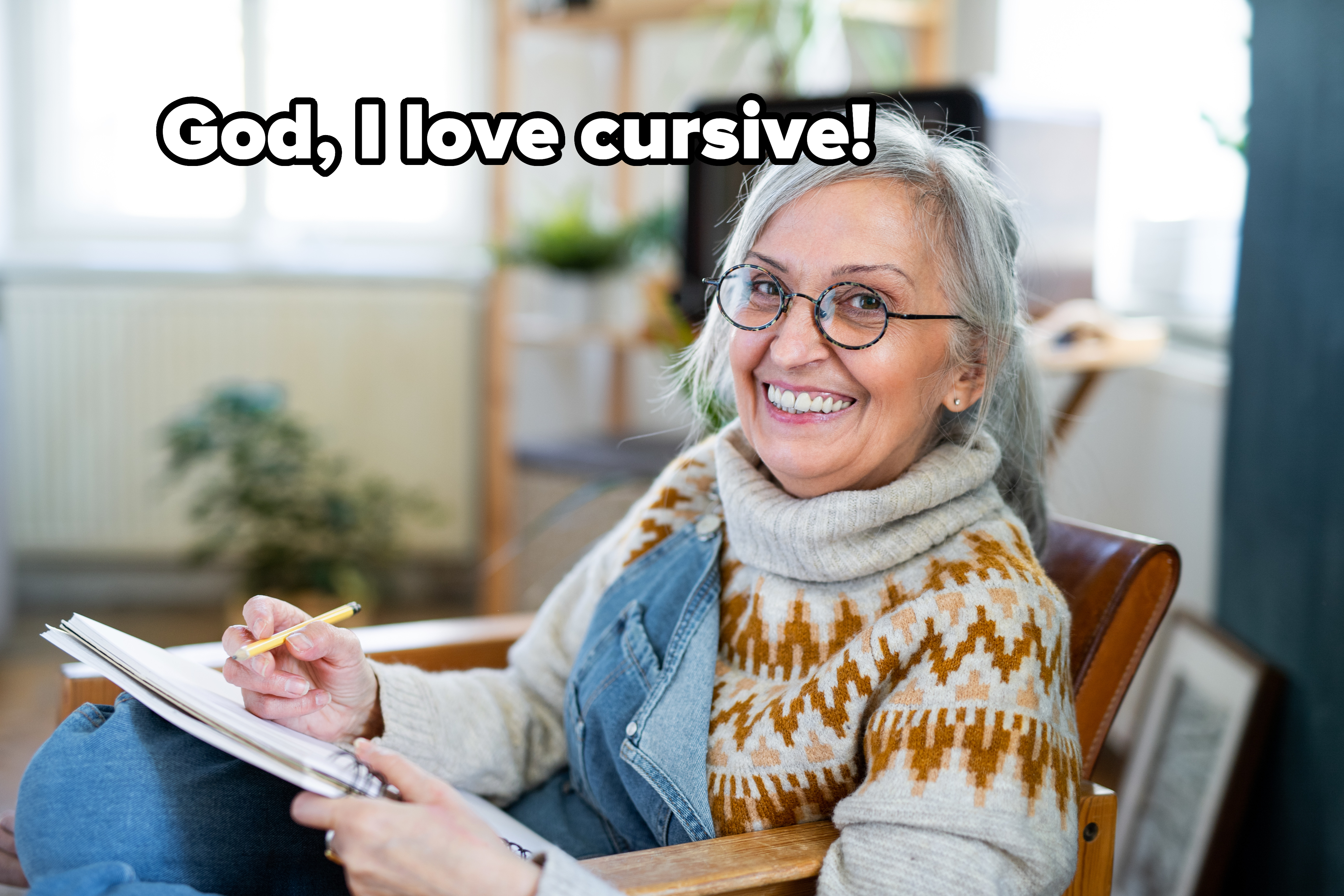 Older smiling woman with a notebook with caption, &quot;God, I love cursive!&quot;