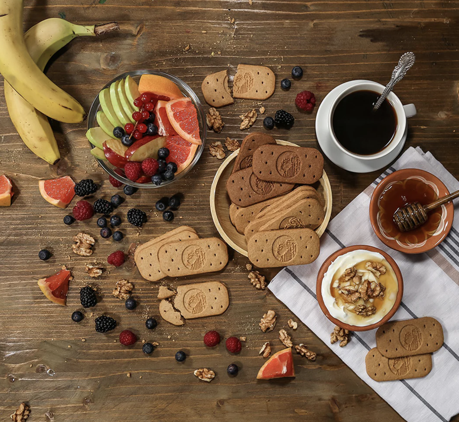 Olyra Foods biscuits surrounded by dippings and fruits.