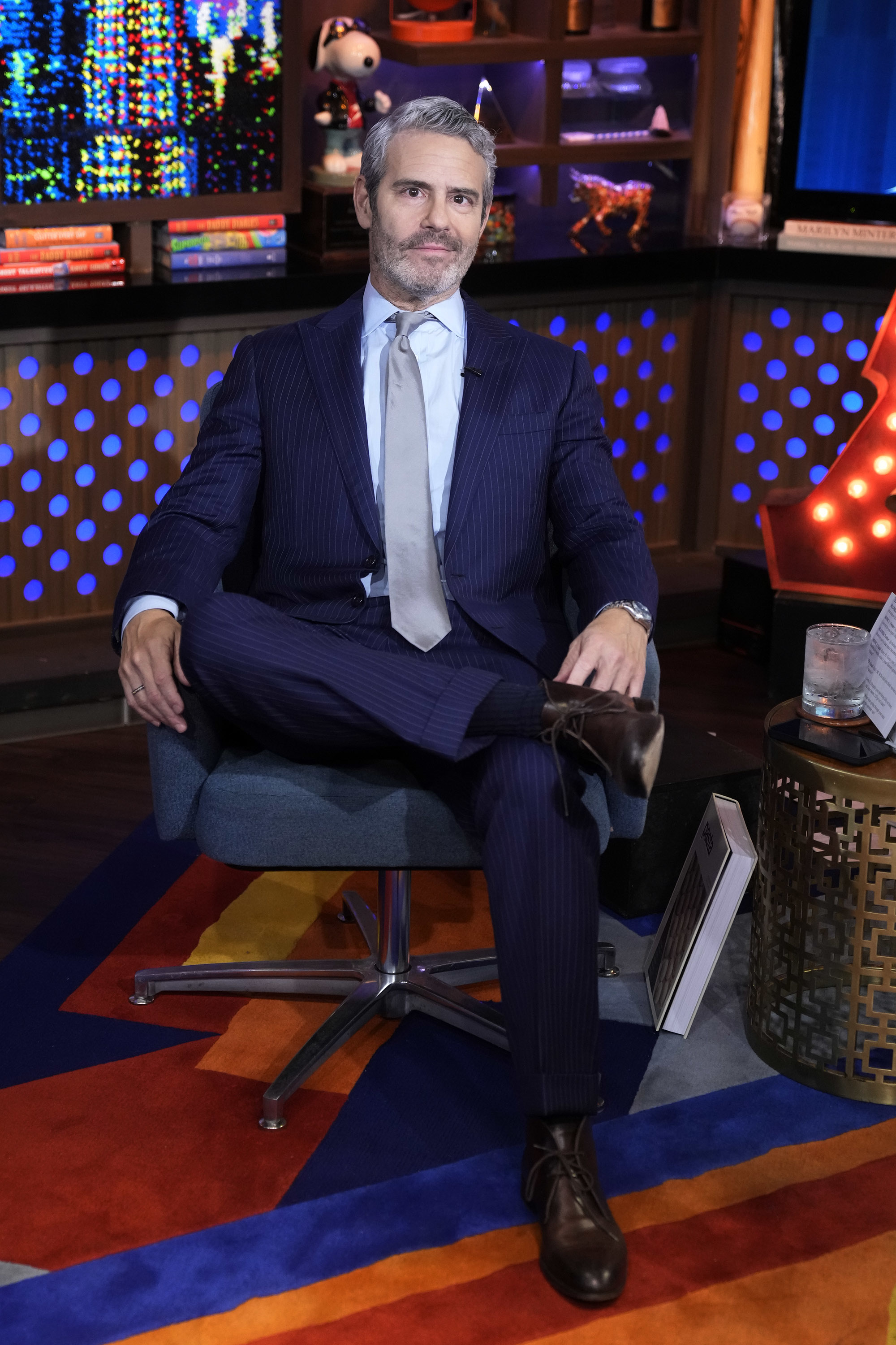 Close-up of Andy seated and wearing a suit