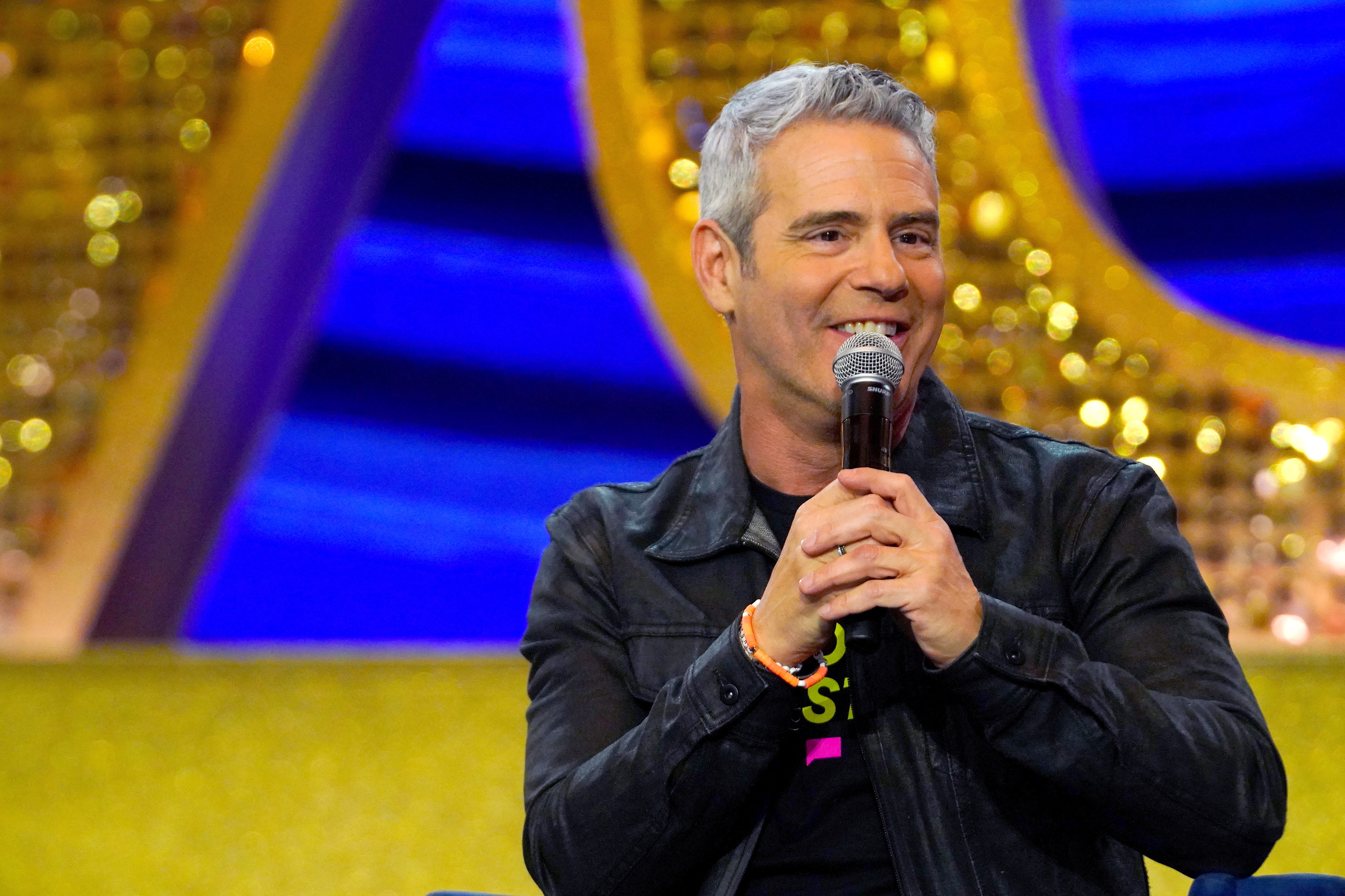 Close-up of Andy holding a microphone