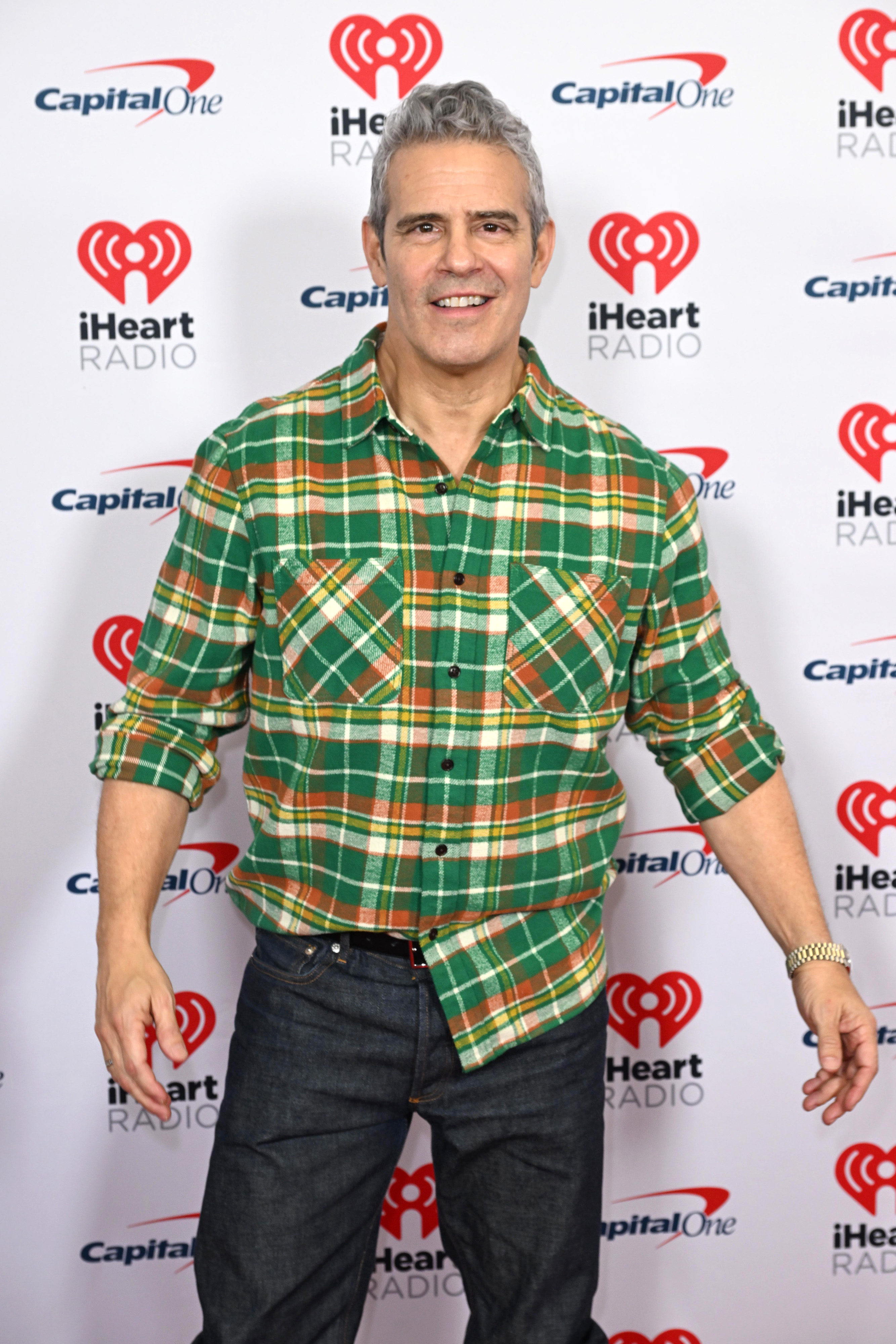 Close-up of Andy in a plaid shirt and jeans at a media event