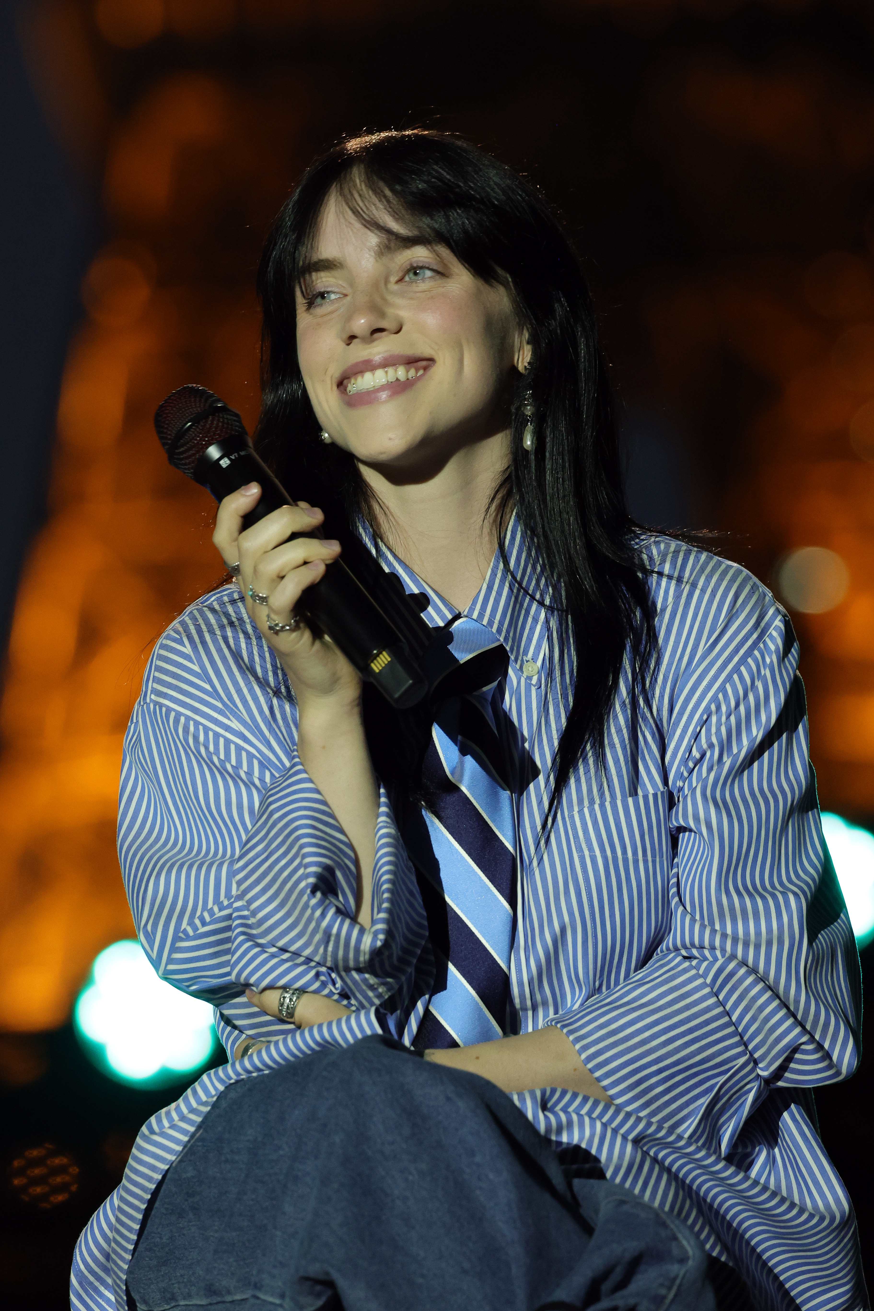 Closeup of Billie Eilish holding a microphone