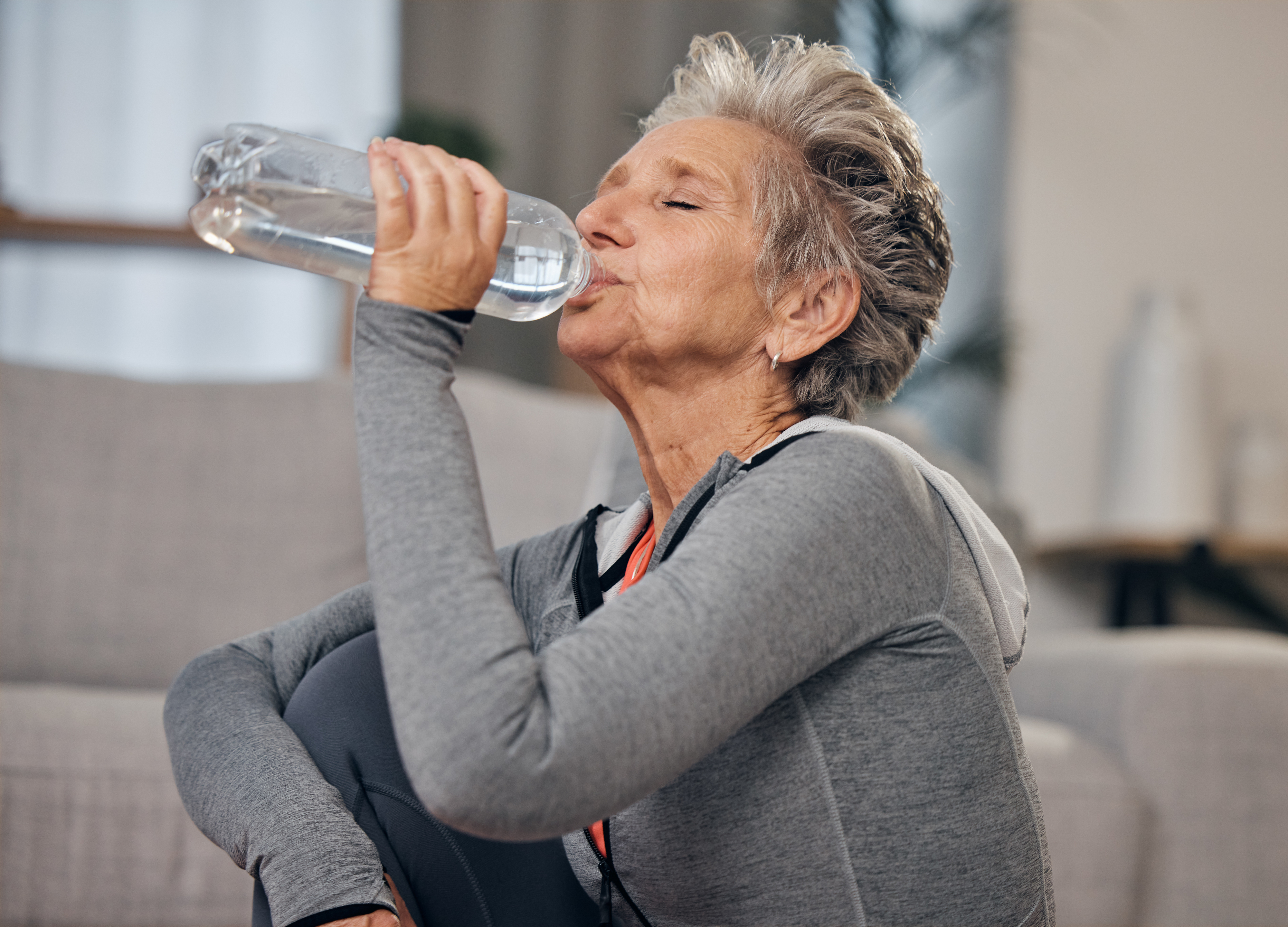 Older woman drinking water from a bottle