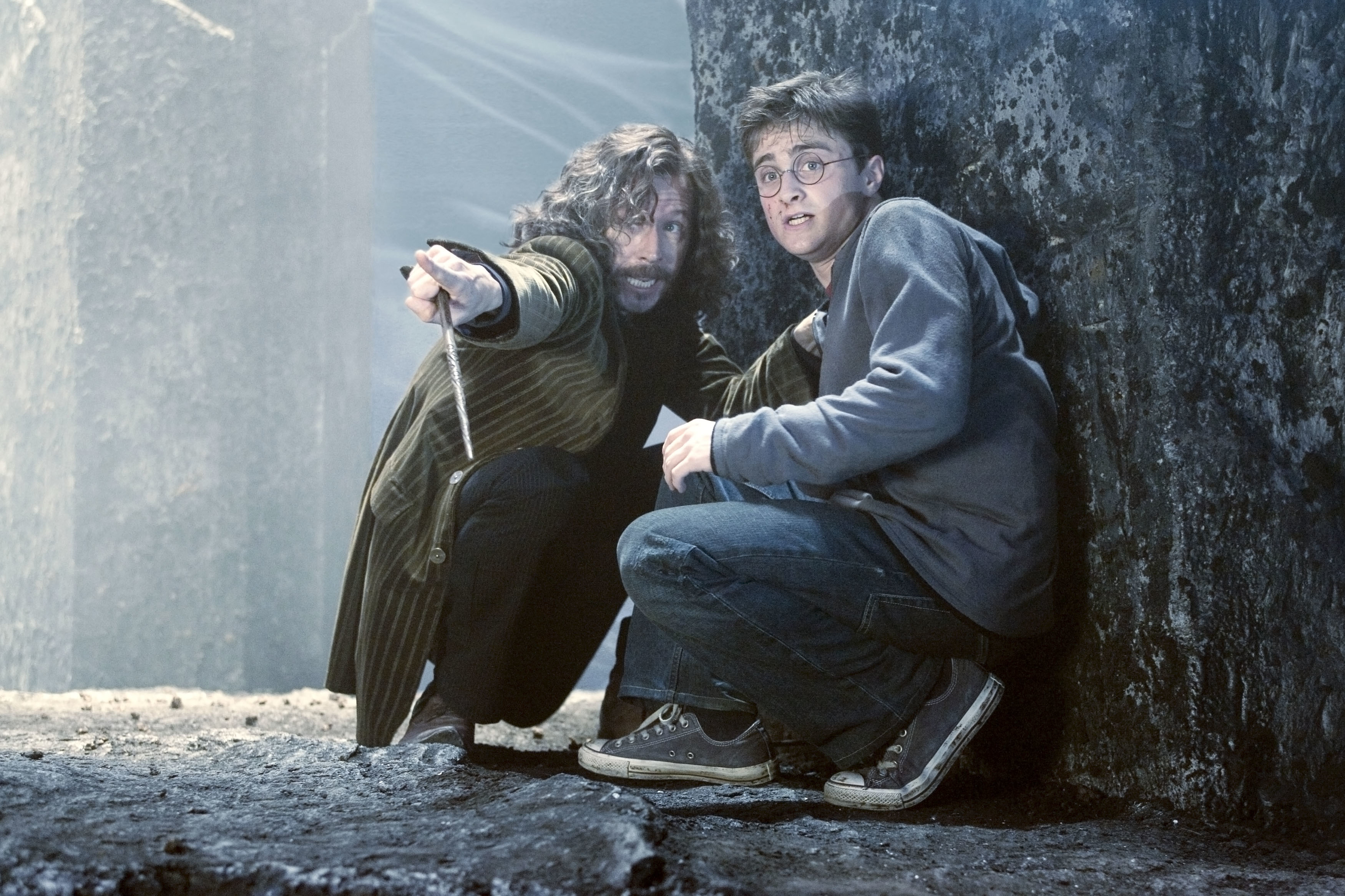 Sirius Black crouching next to Harry Potter