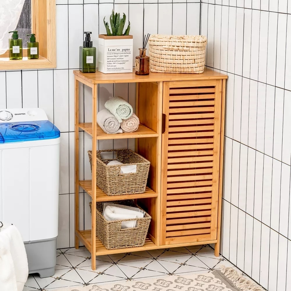 the bamboo cabinet in the corner of a bathroom.