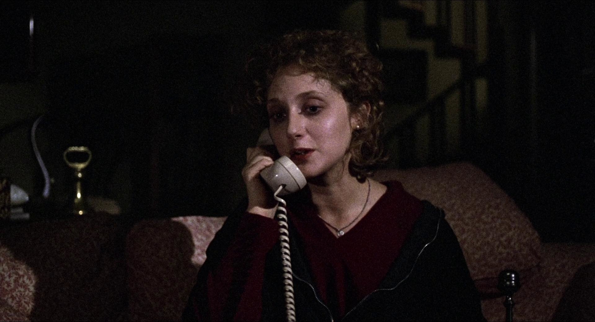 Carol Kane holding a landline phone.