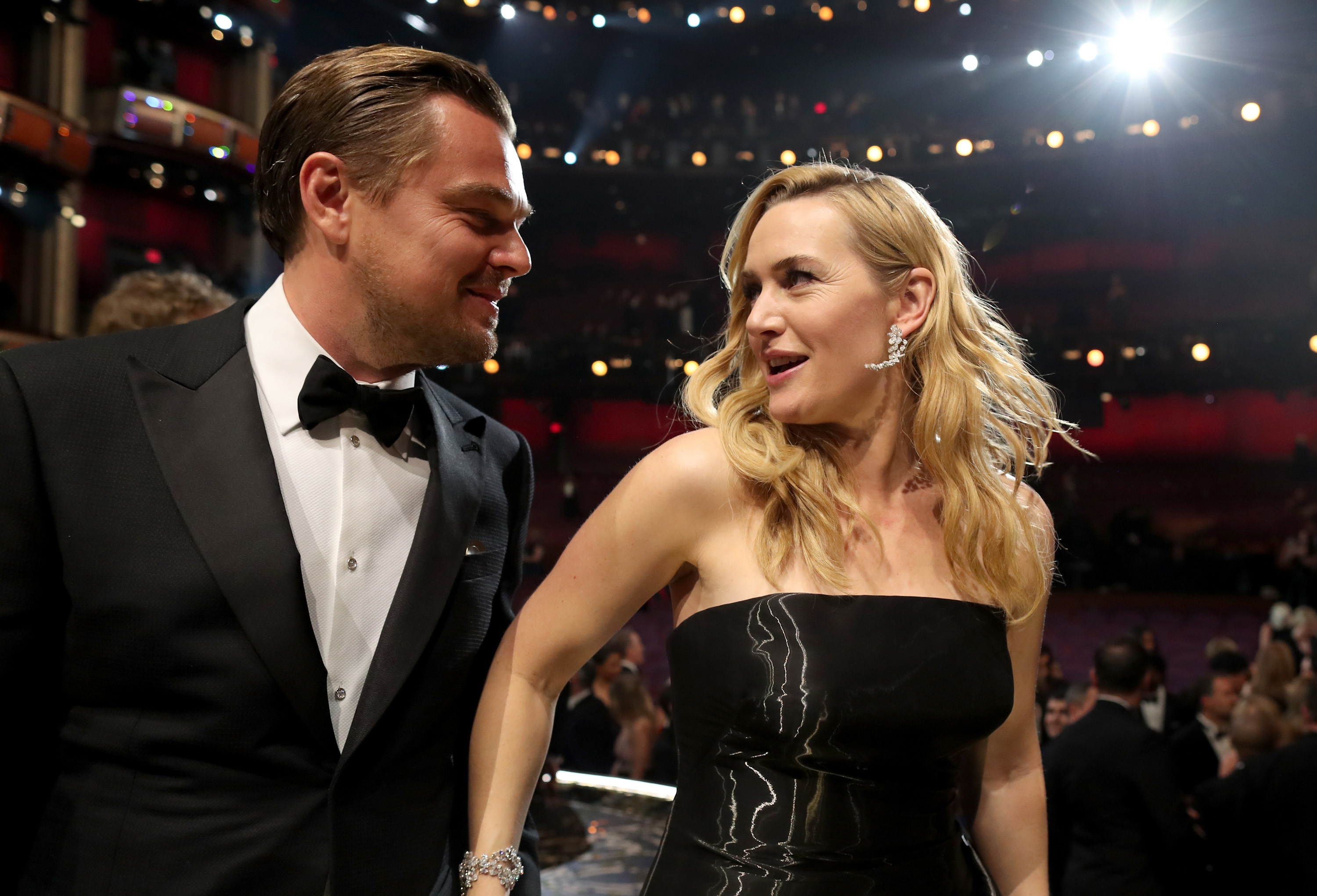 Leo and Kate smiling at each other at an event