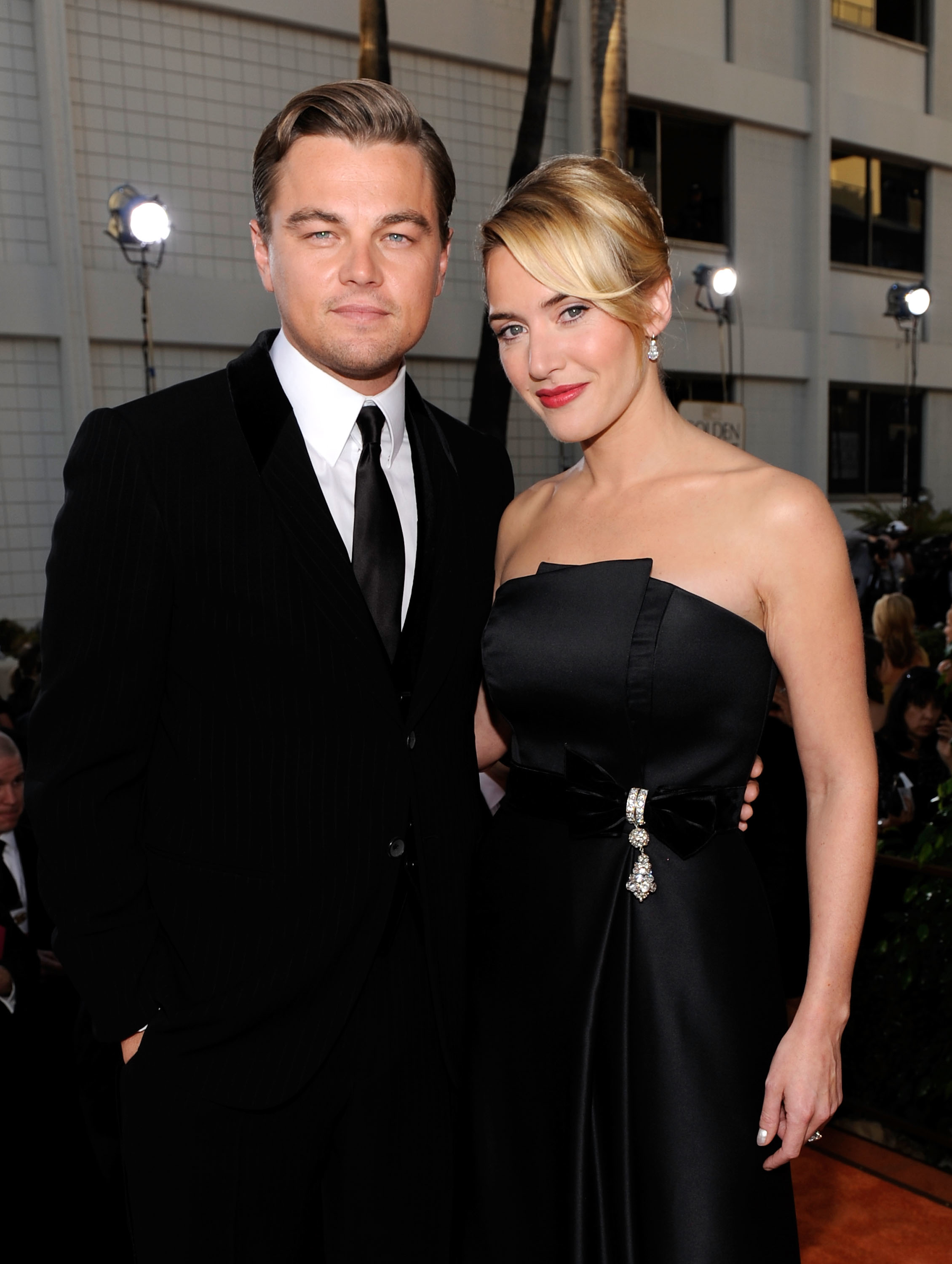 Leo in a suit and tie and Kate in a strapless gown