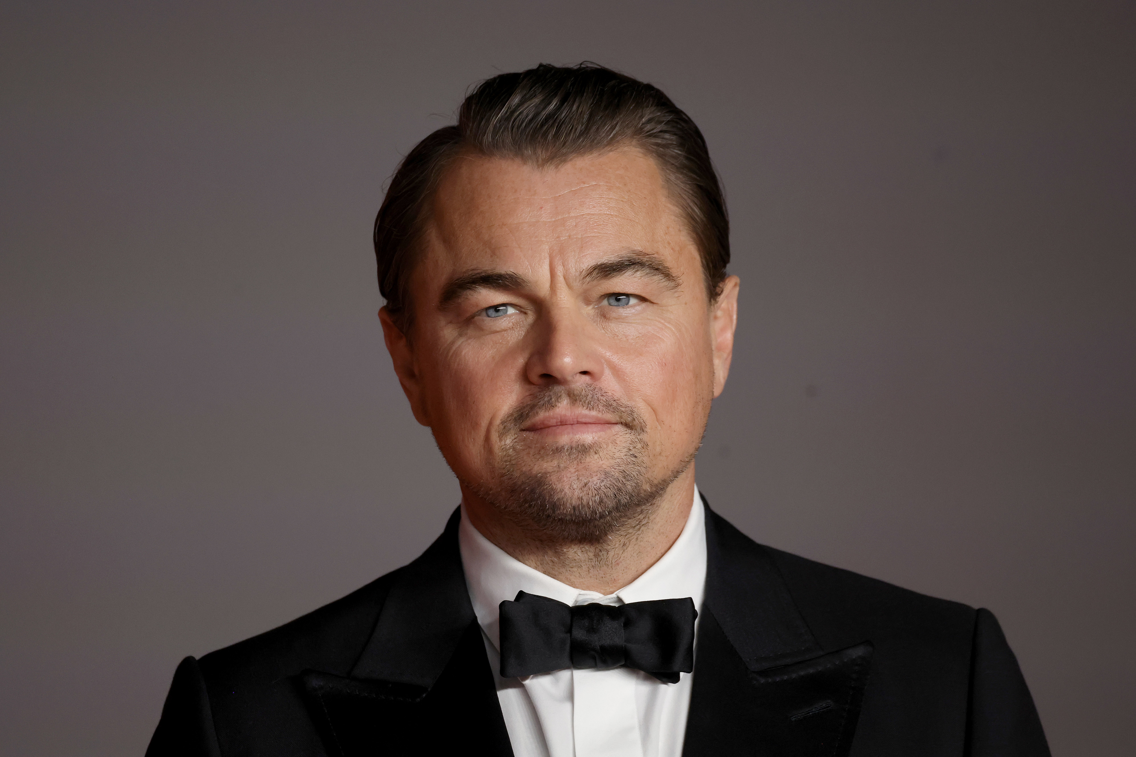 Close-up of Leo in a suit and bow tie