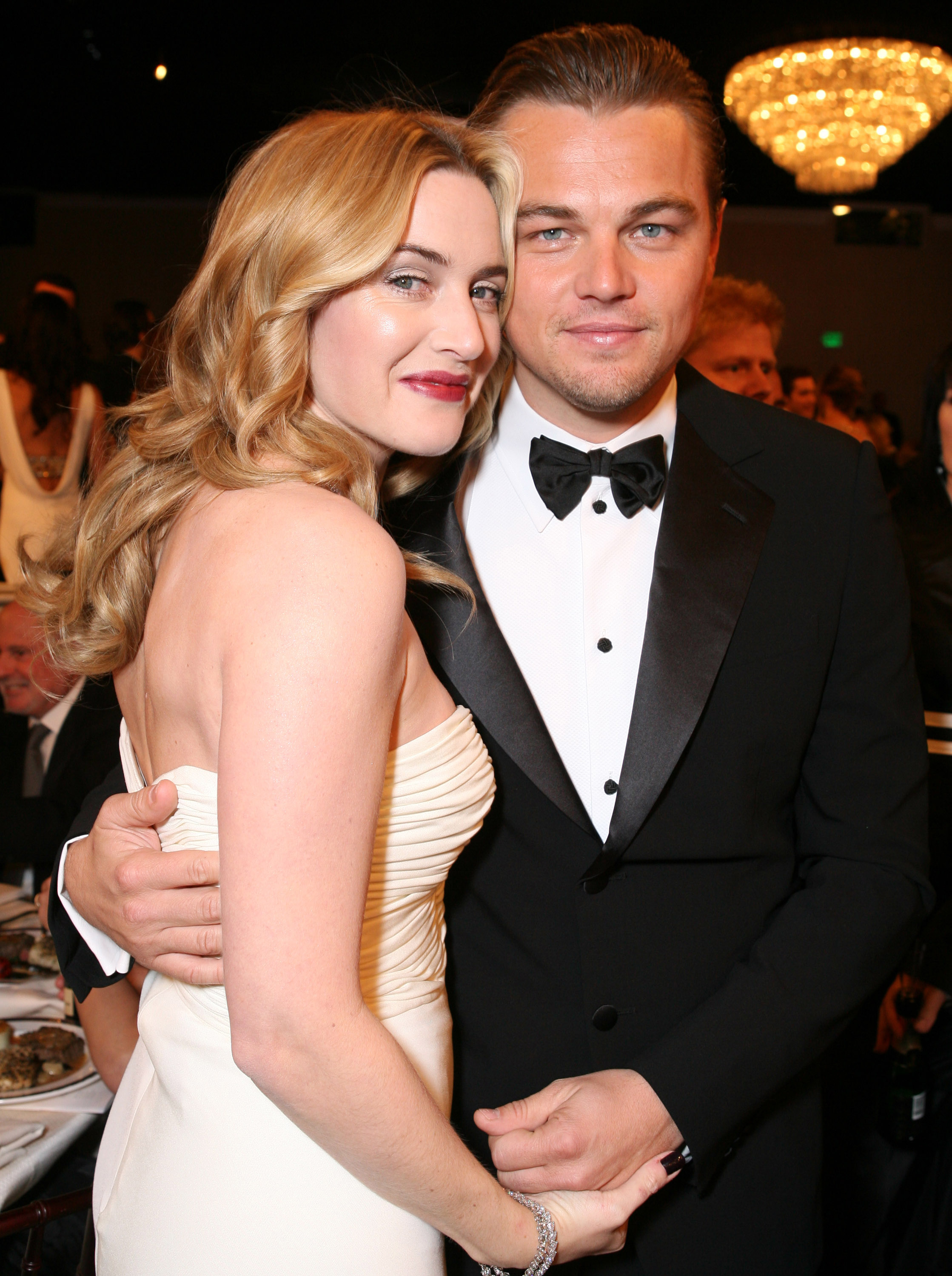 Leo and Kate smiling and embracing