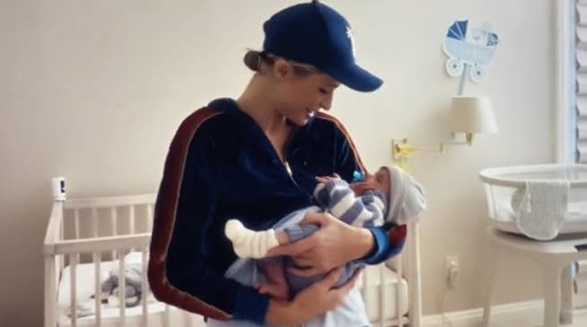 Paris holding her baby son in his nursery room