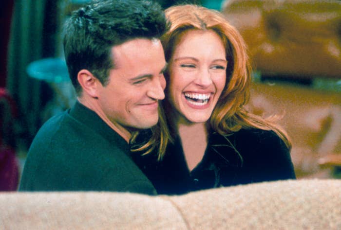 The two actors smiling on set