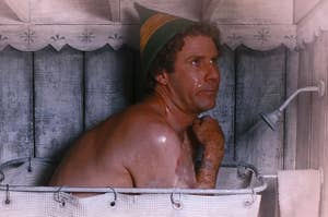 Will Ferrell hunched over in a small shower as Buddy in Elf