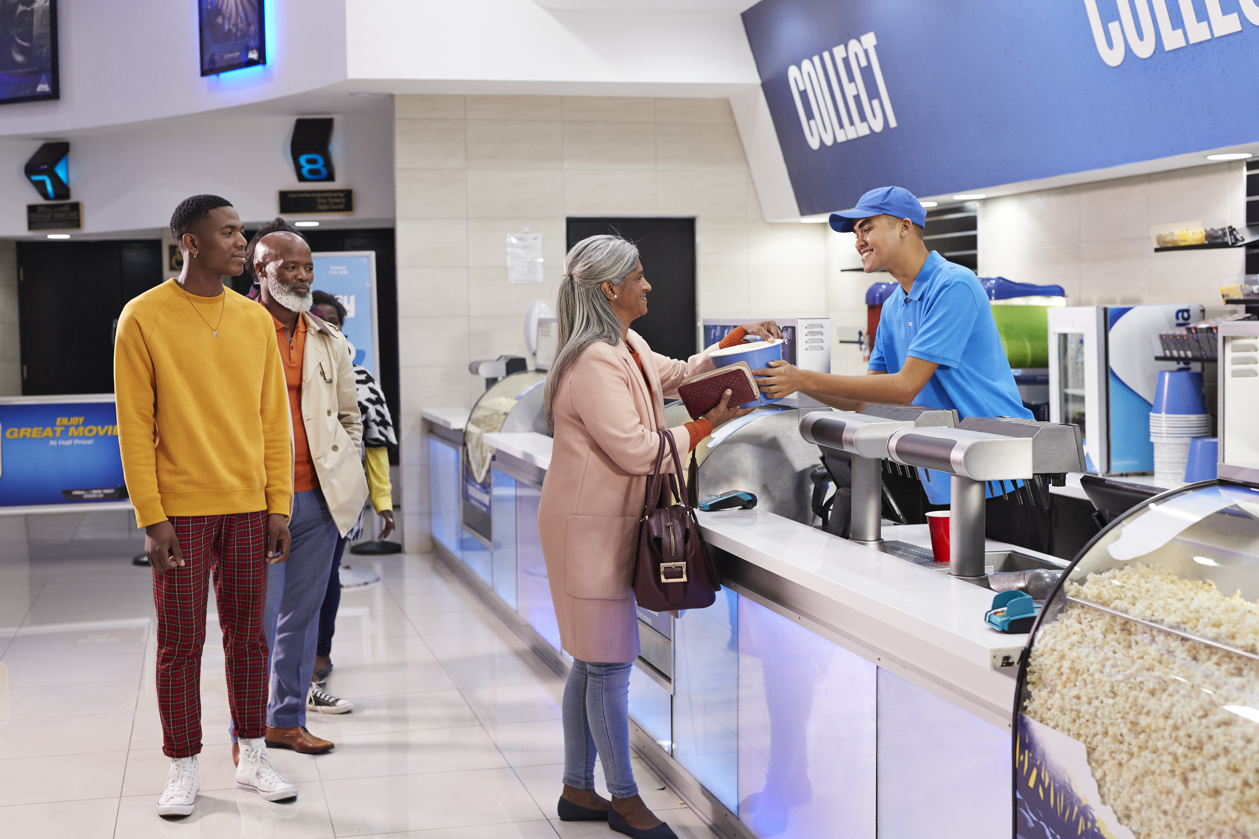 people at the movie concession stand