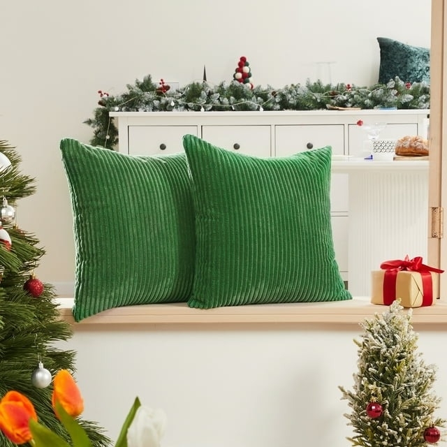 two of the gren corduroy pillow covers with trees around them