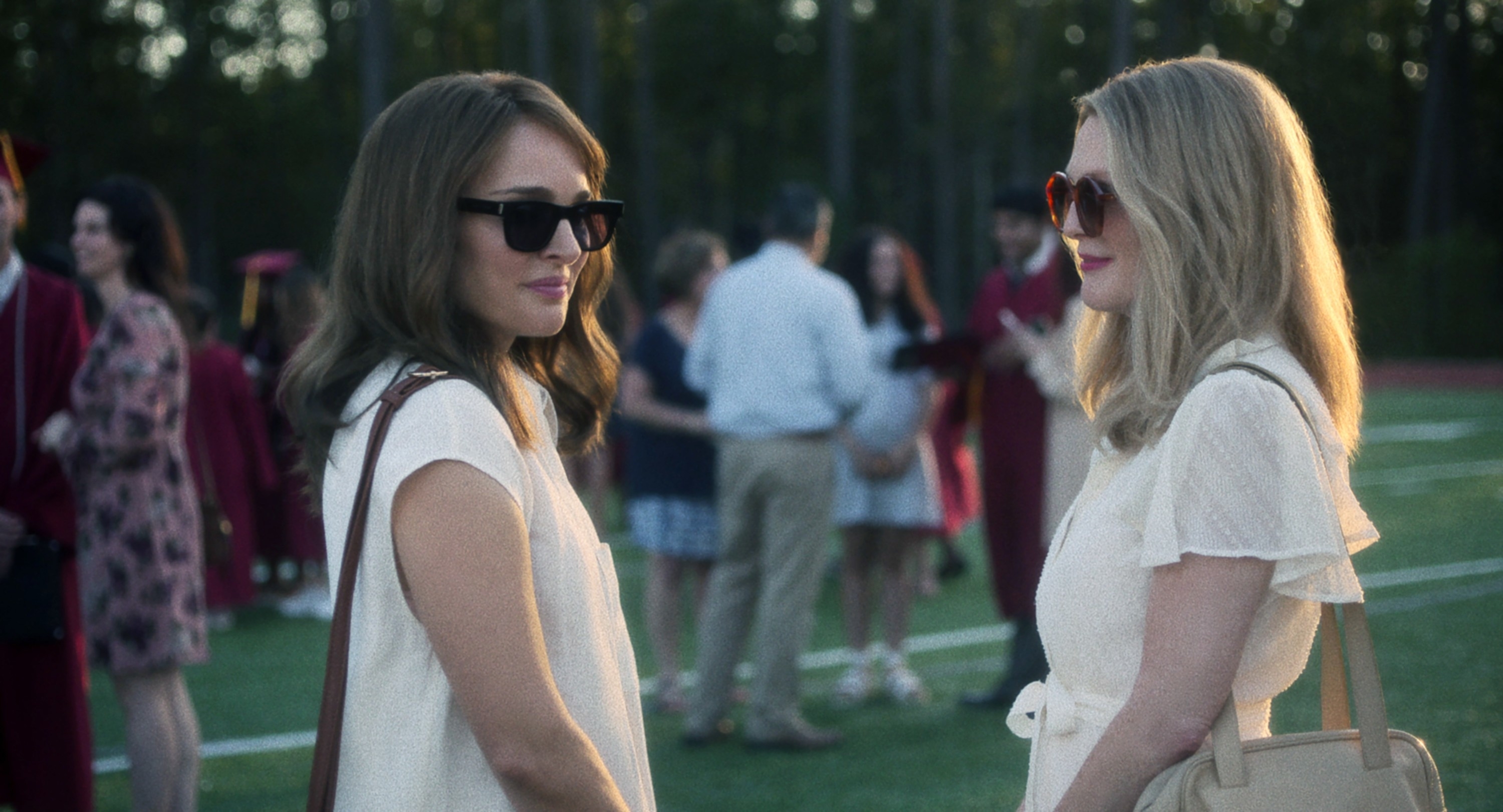 Juliane and Natalie facing each other outside in a scene from "May December"
