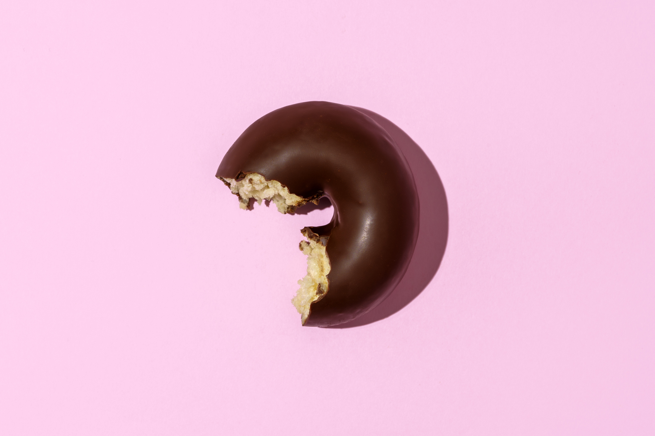A half-eaten chocolate donut