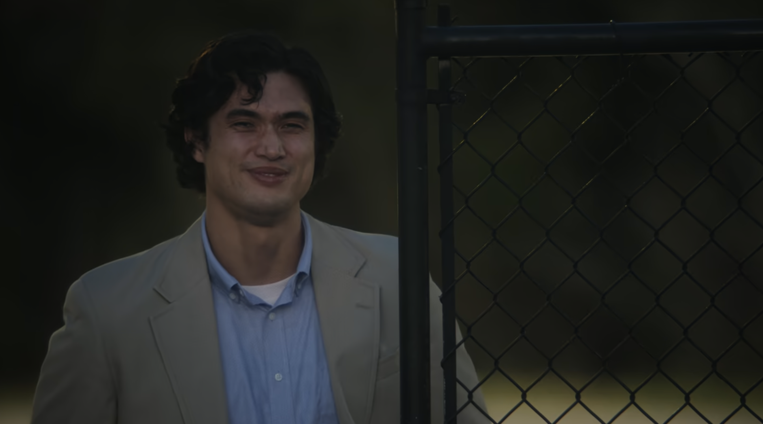 Joe slightly smiling in a scene from &quot;May December&quot;