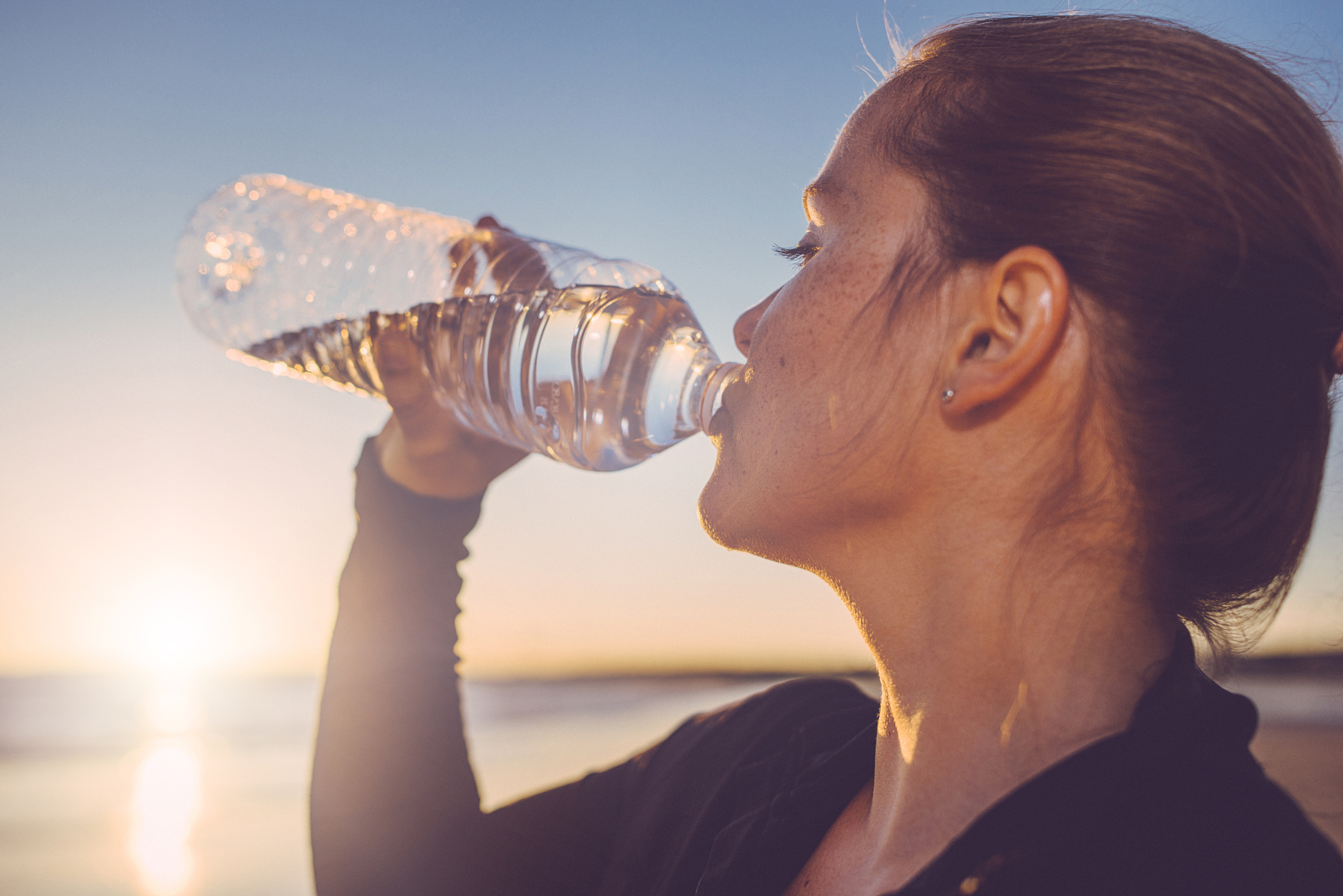Woman drinking water from a bottled water bottle