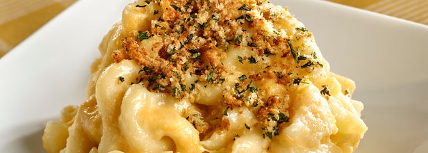 On the left, some mac and cheese topped with some herbs and bread crumbs
