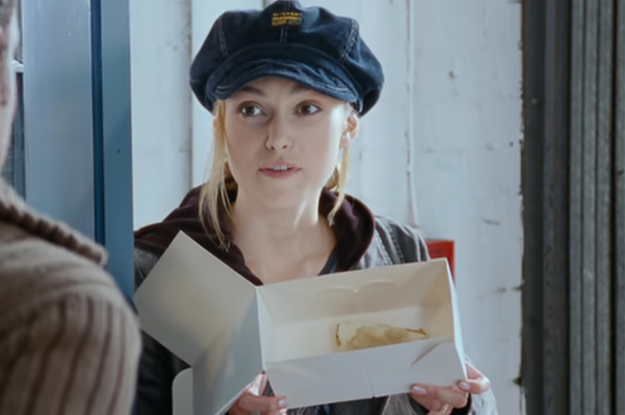 Keira Knightley holding a box with a piece of pie in it as Juliet in Love Actually