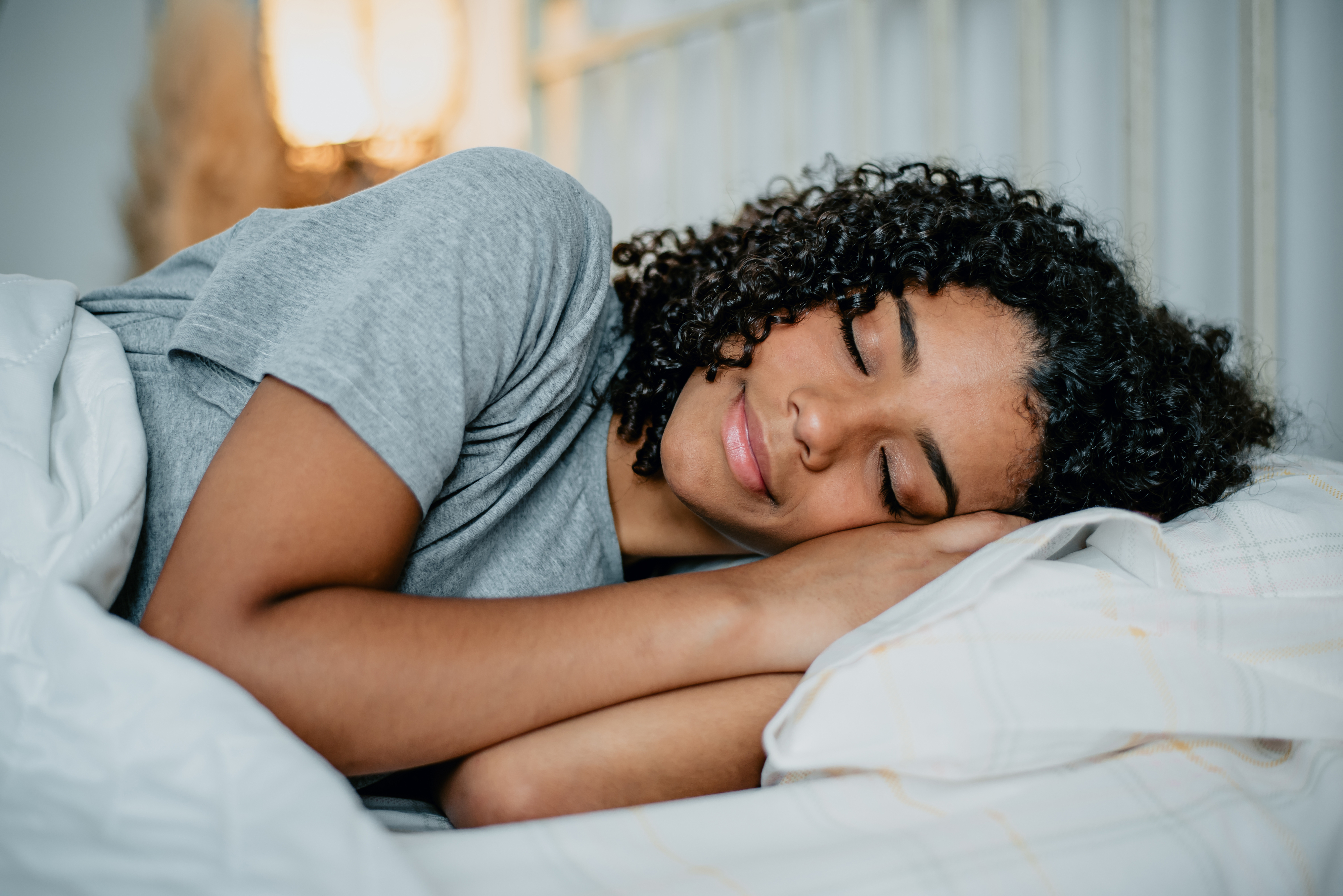 A teen girl sleeping in on the weekend