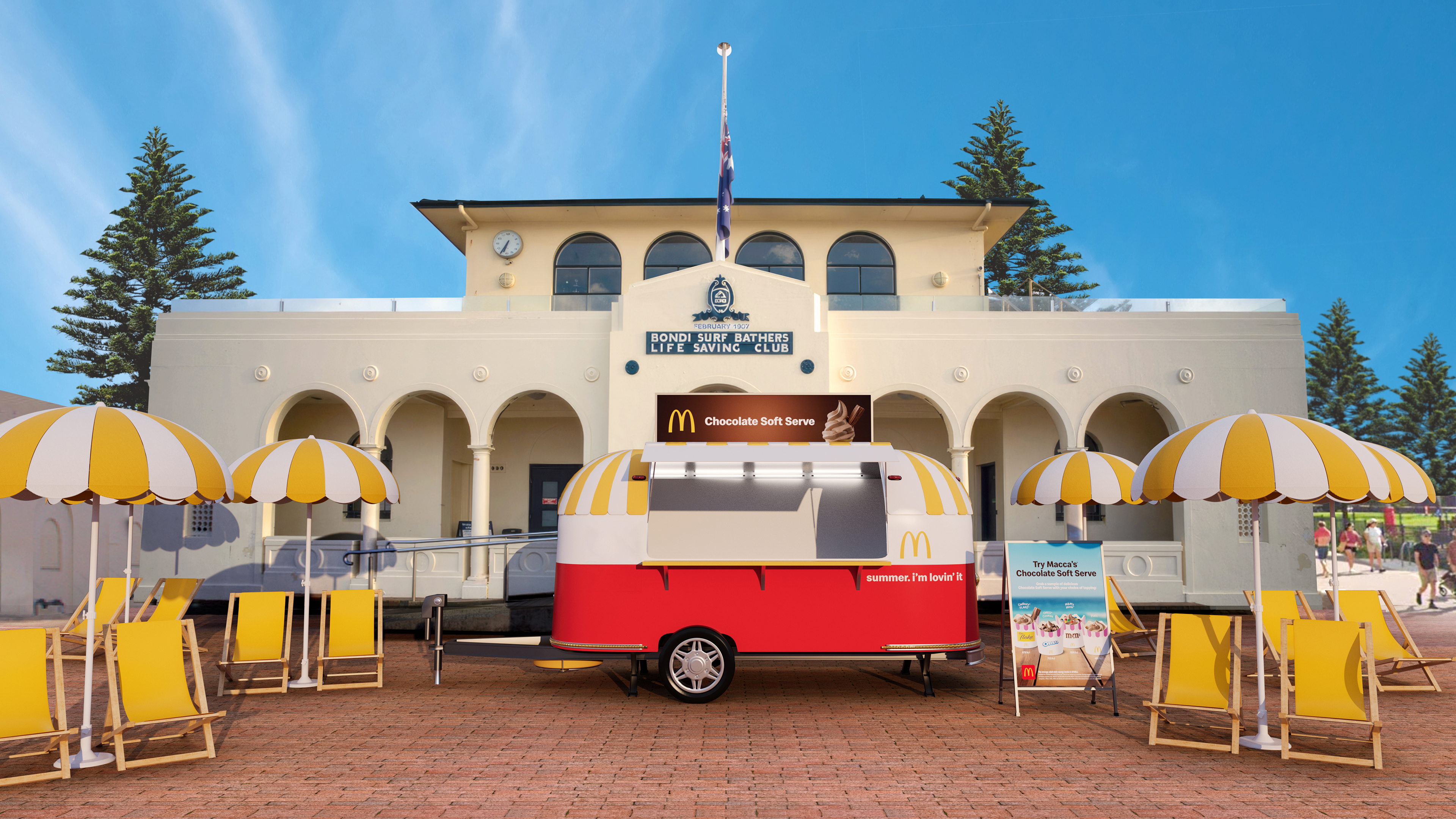 A Macca&#x27;s Soft Serve Van, in red, flanked by yellow beach umbrellas.