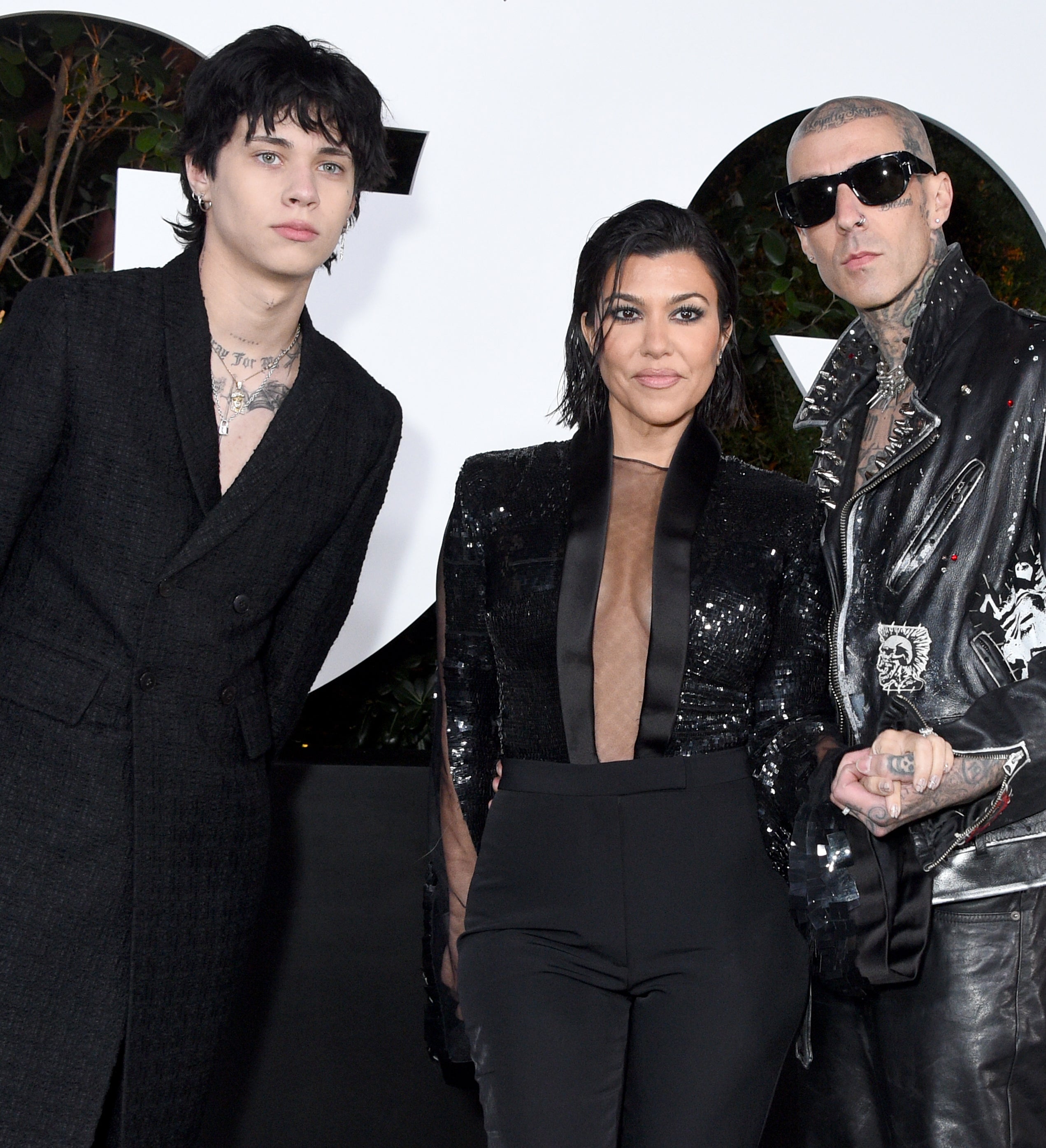From left to right: Landon, Kourtney, and Travis at a media event