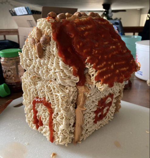 dried ramen made into a house glued together by peanut butter with hot sauce to draw the doors and windows