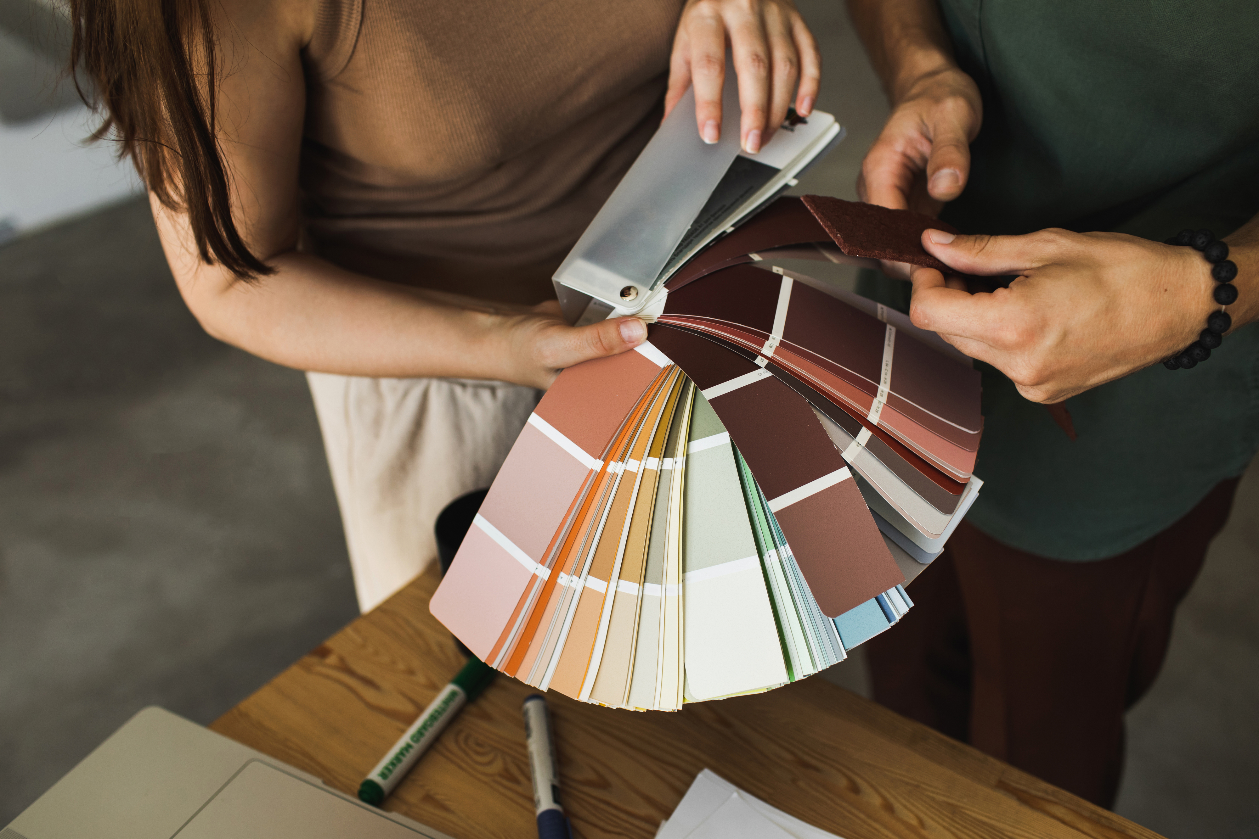 two people looking through a color wheel of paint colors