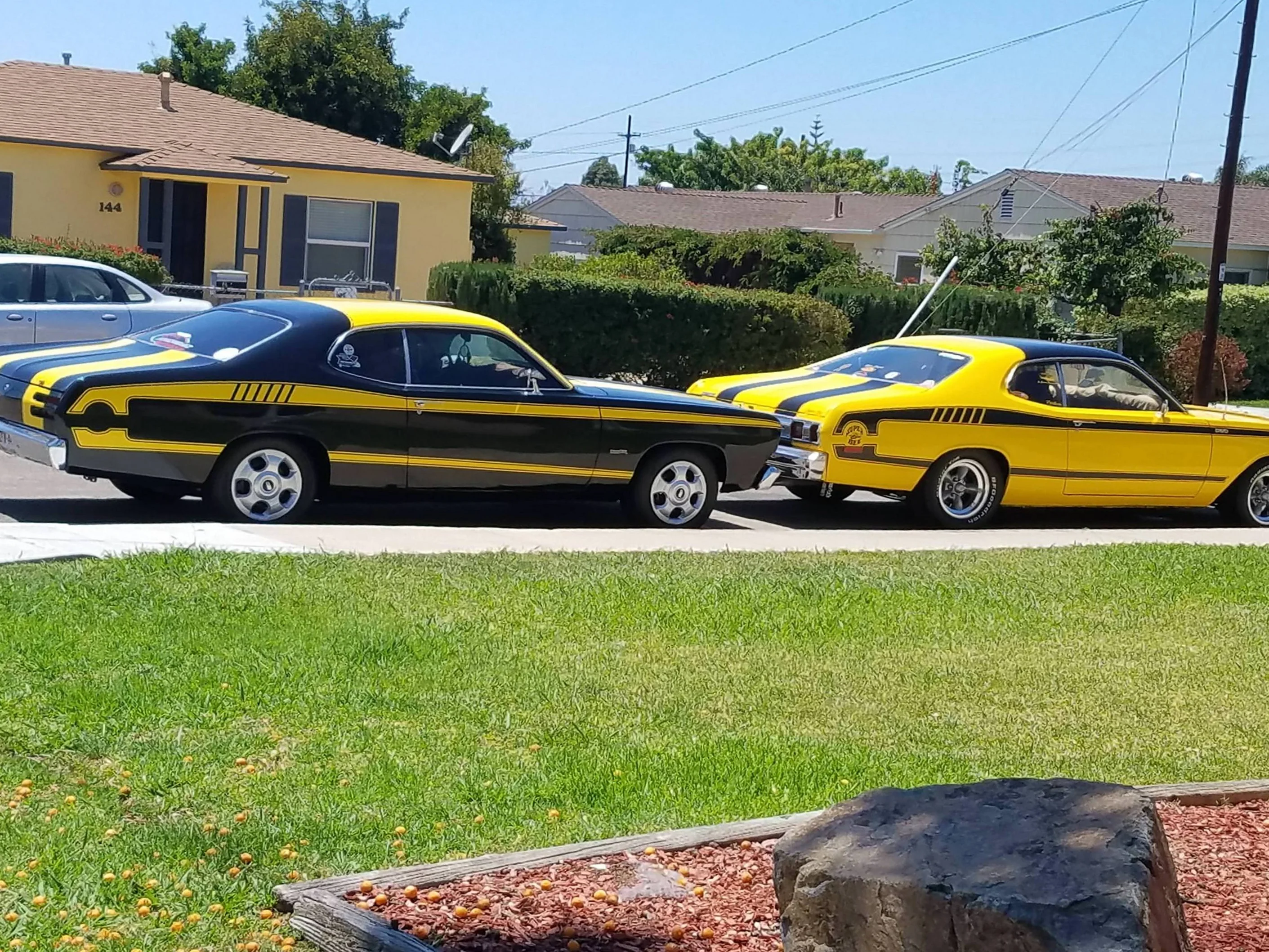 Two yellow and black cars parked next to each other