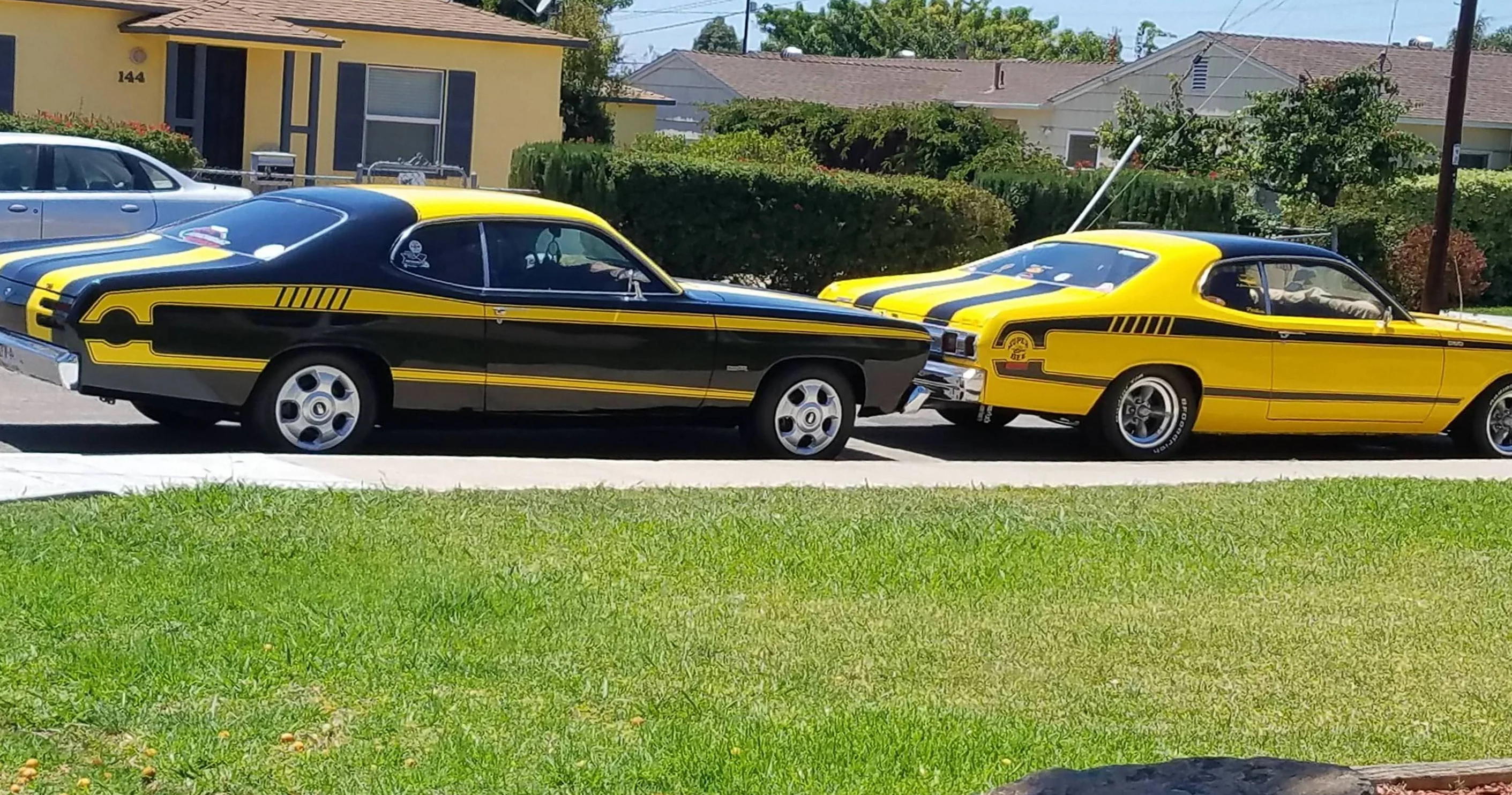 Two yellow and black cars parked next to each other
