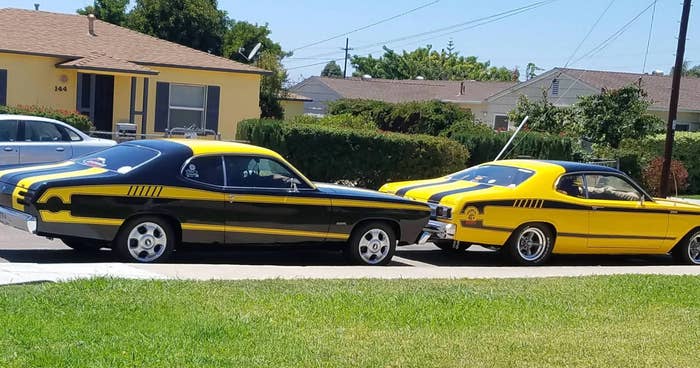Two yellow and black cars parked next to each other