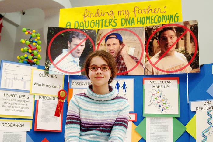 closeup of a teen in front of a science fair project to find out who her dad is