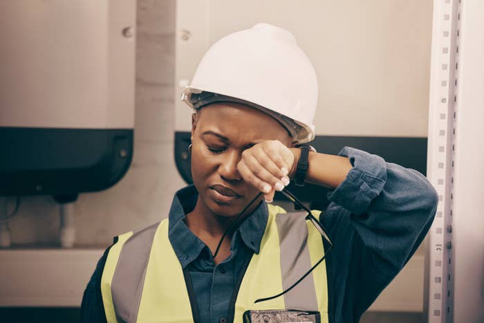 exhausted employee in a hard hat