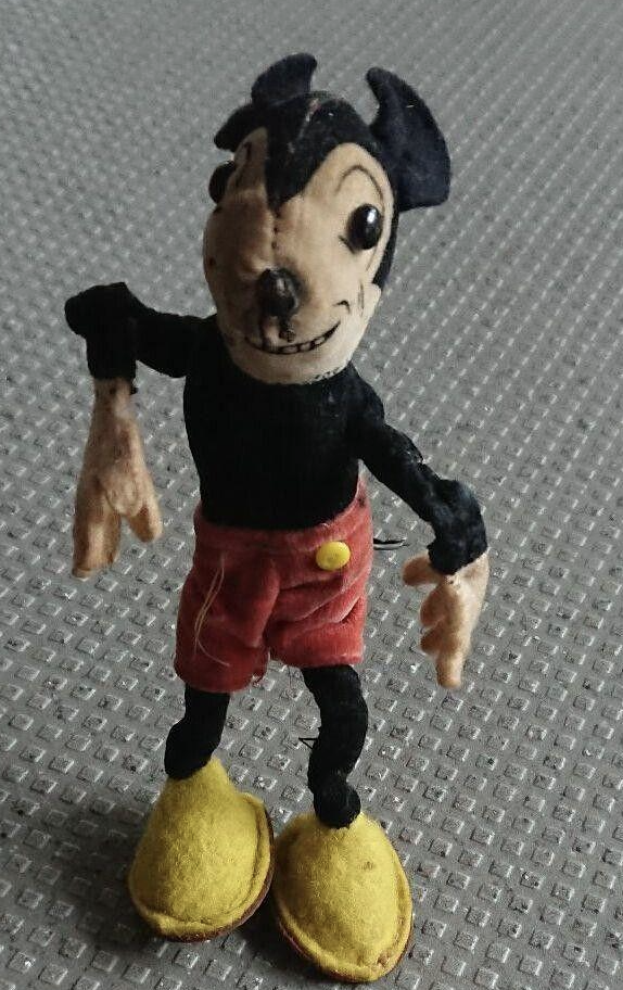 Mickey&#x27;s face is distorted, the eyes too far apart, and his arms are dangling and look broken