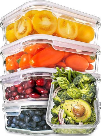 the stacked clear containers full of fruits and veggies