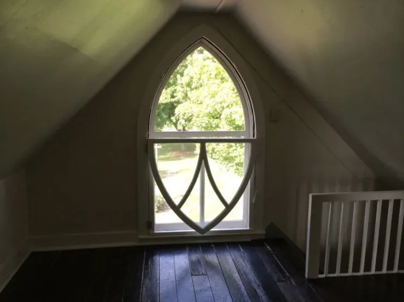 The inside of the attic whose window is seen at the top of the painting in the background