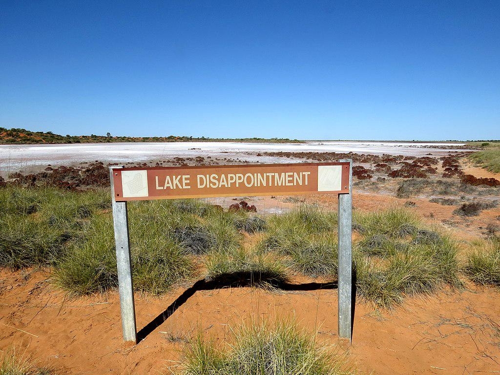 A &quot;Lake Disappointment&quot; sign amid an arid landscape