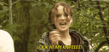 Woman waving a fake knife.