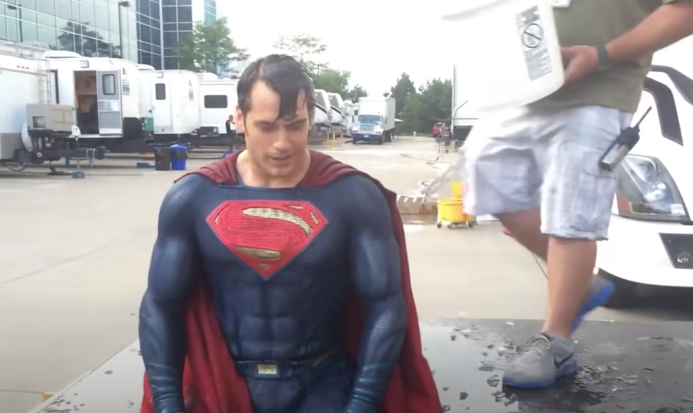 Henry Cavill dressed as Superman doused in water
